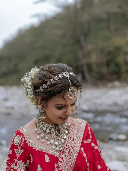 A delicate and soft portrait of the bride looking down, highlighting her beautiful jewelry and makeup.
