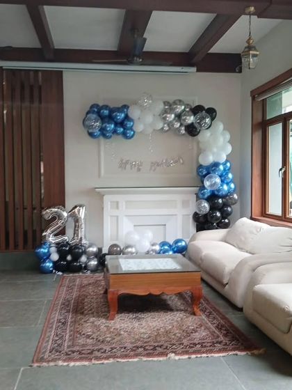 Another angle of the 21st birthday setup, highlighting the balloon arch over the fireplace mantel.
