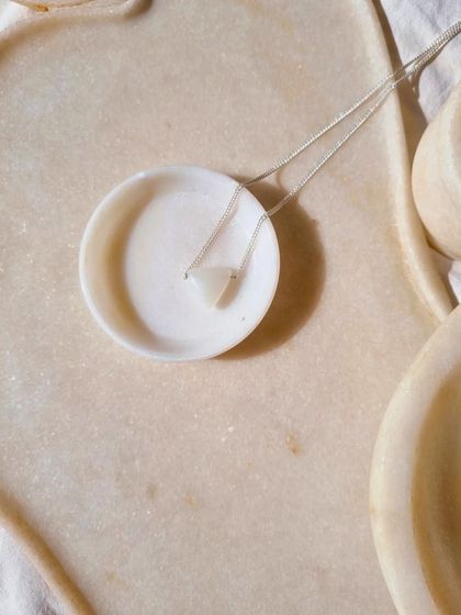 The White Moonstone Tikona pendant for men, a charm for good luck.