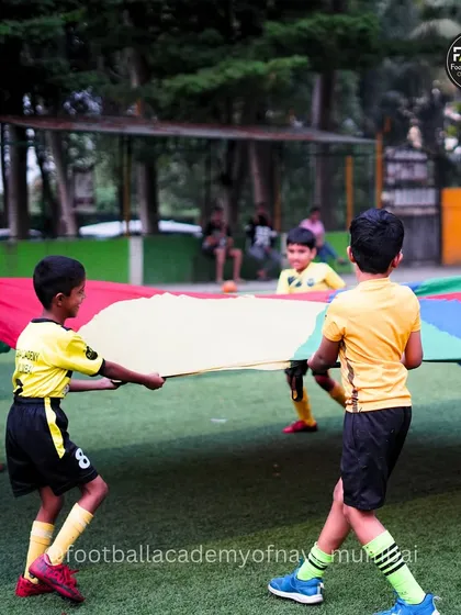 It's not all drills and matches. We use fun, engaging activities like this parachute game to build teamwork, coordination, and friendships among our youngest players in a vibrant and energetic atmosphere.