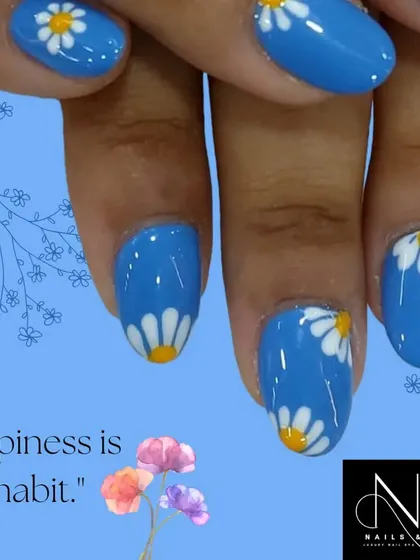 Brighten your day with this cheerful daisy nail art. We used a vibrant blue as the base to make the simple, hand-painted white and yellow flowers pop.
