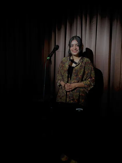 A smile in the spotlight. Performing poetry is a source of immense joy and a way for me to process the world around me.