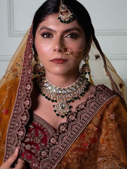 A close-up of this regal bridal look. The detailed eye work, combined with a perfectly sculpted face and bold lip, shows the professional level our students achieve.