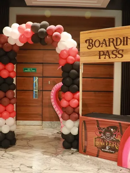 A creative entrance for a pirate-themed party, designed to look like a boarding pass station with an octopus tentacle prop.