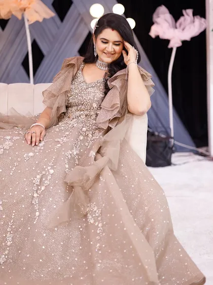 A candid, relaxed shot of the bride on the couch. Even in a casual moment, her reception glam looks absolutely stunning and picture-perfect.