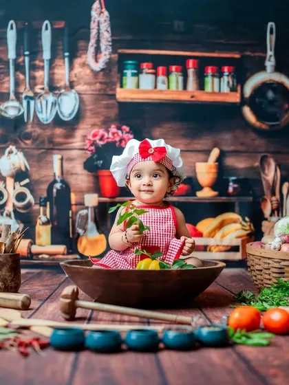 This little one is tasting her leafy greens during her 'Little Chef' photoshoot. I use a variety of real and safe props to make the experience sensory and fun, leading to authentic expressions.