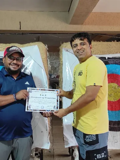 An adult student receives his certificate after finishing the Basic Archery Course. This is the first step, and we encourage students to continue with our practice batches.
