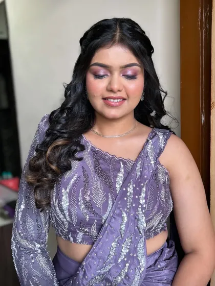 A close-up of a beautiful purple-toned eye makeup look. The shimmer on the lid catches the light beautifully, perfect for an evening event.