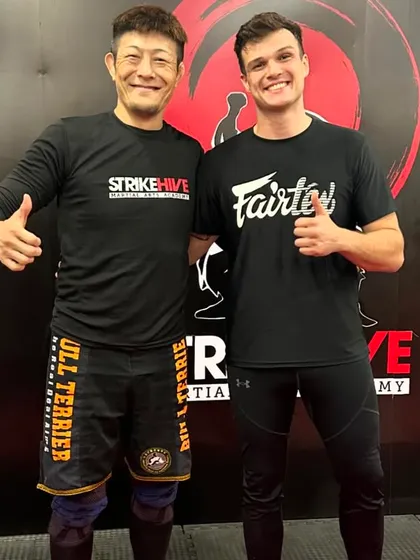 Our coach stands with a BJJ Black Belt from Japan after a seminar, a testament to our commitment to global martial arts collaboration.