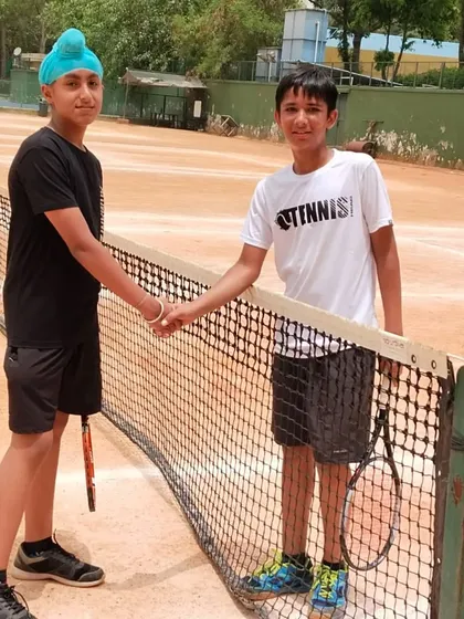 Sportsmanship is as important as winning. Here are my trainees, Gyan and Ansh, shaking hands over the net, showing respect for each other after competing hard.