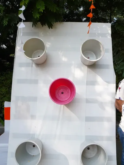 An interactive bucket toss game set up for guest entertainment during the daytime festivities.