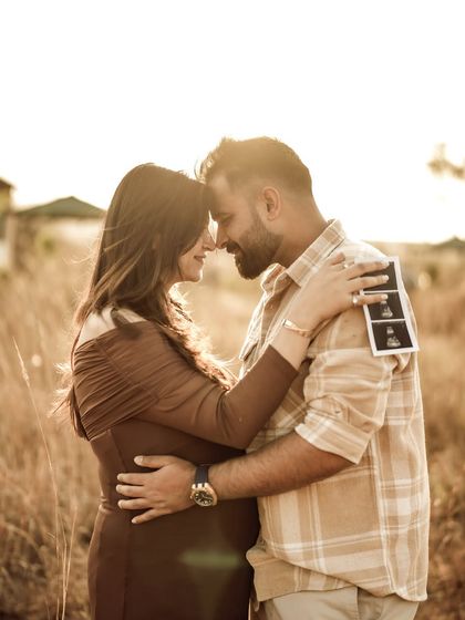 A stunning backlit portrait of the couple embracing. The golden sun creates a beautiful flare, adding a touch of magic to this romantic moment.