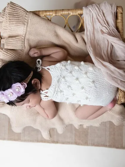 An overhead view shows the beautiful details of the setup, with the newborn nestled in a basket, surrounded by soft fabrics. I carefully style each session to be unique.