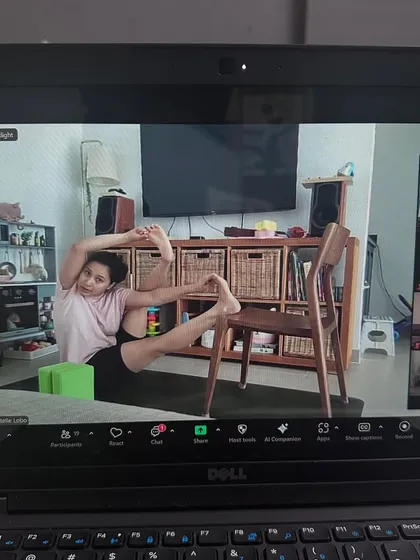 A student in our online class using a block and chair to find her expression of the pose. I encourage everyone to practice according to their body's needs without pushing.