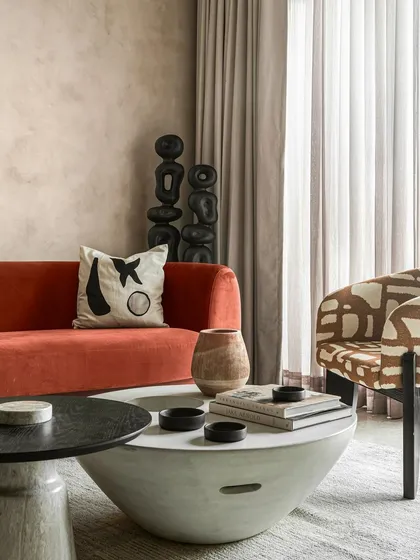 An identical image showcasing the carefully styled coffee tables and decor. Every piece was chosen to contribute to the room's overall theme of texture, pattern, and earthy color.