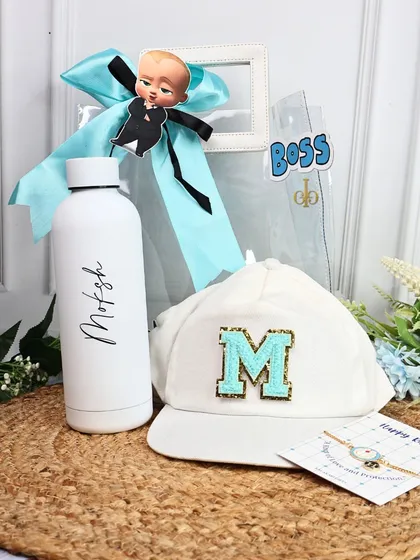 Our "Boss Baby" themed Rakhi hamper for the little boss in your life. It includes a personalized water bottle, a monogrammed cap, and a Rakhi, all packed in a clear tote.