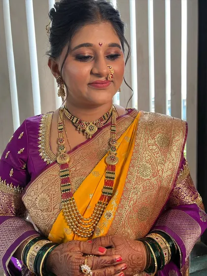 A close-up of the eye makeup and flawless skin finish. I use brown and gold tones that are universally flattering for Indian skin.