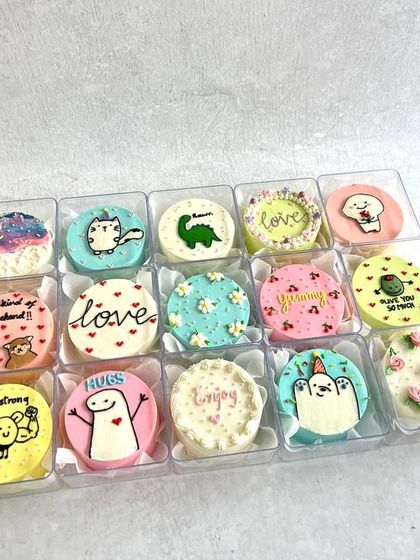A weekend assortment of mini bento cakes, featuring a mix of cute characters, floral designs, and encouraging messages.