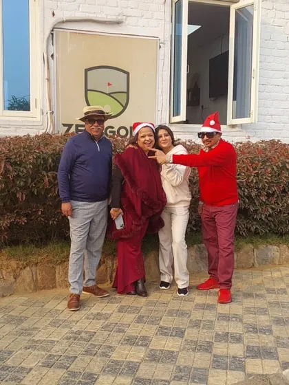 A family gets into the festive spirit with Santa hats outside our main building during the Christmas holidays.