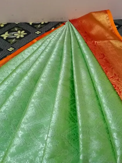 A lovely light green saree, possibly a cotton blend, pleated and ready. My service is perfect for your everyday elegant sarees too.