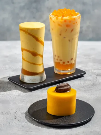 A mango-themed beverage duo, featuring a mango bubble tea and a mango smoothie.