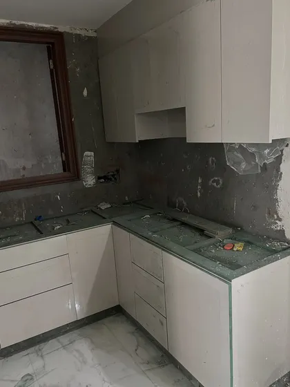 A sneak peek from a site in progress. This shows the initial installation of modular kitchen cabinets against the unfinished wall, with the countertop yet to be placed.