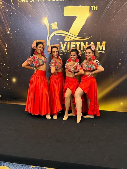 Our all-girls team posing backstage at the Vietnam International Latin Festival. We are so proud to take our routines to international stages.