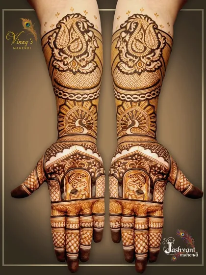 A grand, symmetrical design featuring elephants in jharokhas on the palms and peacocks on the forearms. This is a perfect choice for a VIP guest or family member.