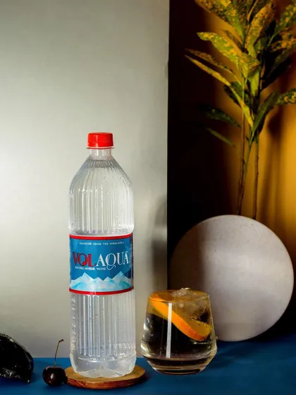 A modern, abstract composition for Volaqua water. The use of geometric shapes, contrasting colors, and interesting shadows creates a contemporary and stylish product shot.