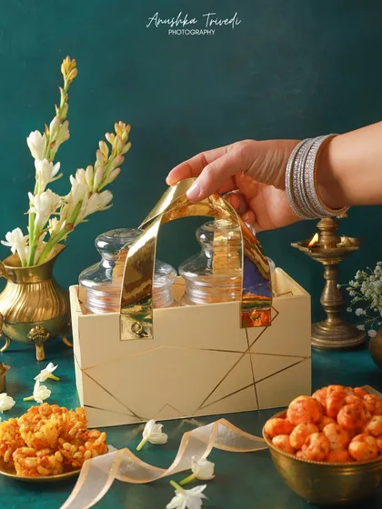 A lifestyle shot of the hamper being held, creating a sense of gifting and celebration. The focus is on the action of giving, making the product more relatable.