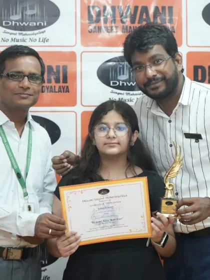 A student receives her award from our instructors, a proud moment for the Dhwani family.