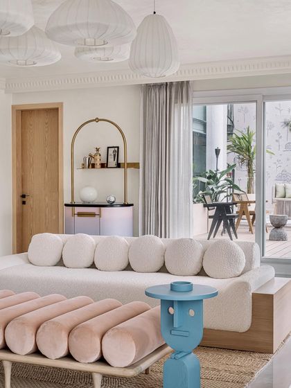 The living room at Eden House, with its playful furniture and view to the outdoor deck, is a perfect example of our whimsical yet balanced design approach.