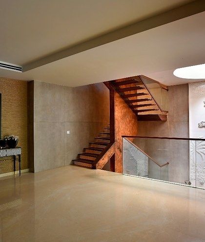 The staircase landing is designed as a clean, open space, allowing the sculptural form of the stairs and the detailed art panel to be the heroes.