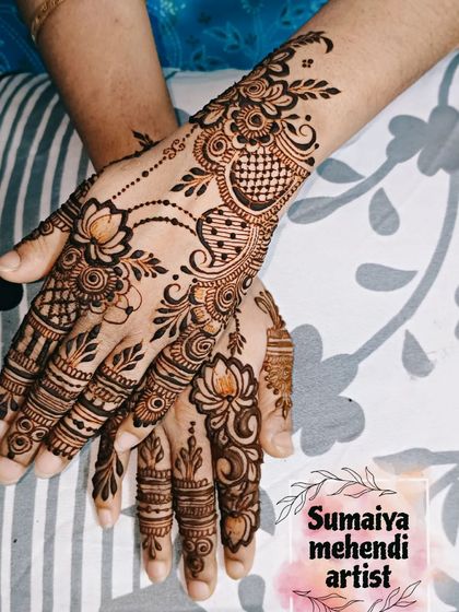 A lovely party henna design with lotus motifs and delicate chains.