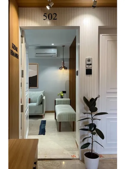 The view from the entrance reveals an inviting living space. We design entryways that offer an immediate sense of warmth and a glimpse into the home's unique personality.