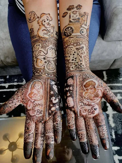 Celebrating the journey to motherhood with personalized baby shower mehndi. This design includes sweet portraits of the parents-to-be, along with adorable baby-themed elements like a toy train and a stork.