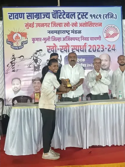 A young player receiving an award at the district championship selection trials.