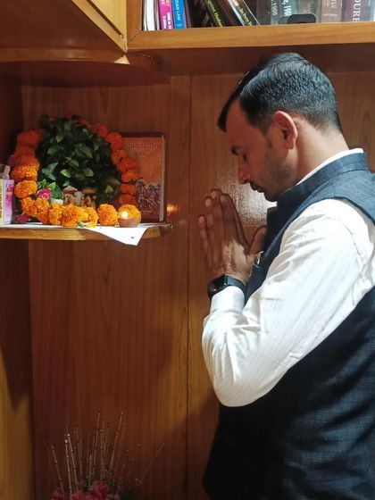 Praying at the small shrine in my office. Faith and spirituality provide strength and guidance in our challenging work.