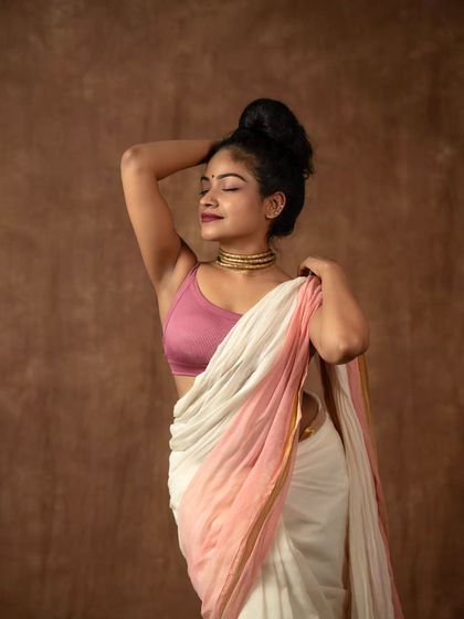 Exploring different moods and silhouettes. Here, the pallu is draped loosely to create a soft, artistic effect, paired with a simple top knot.