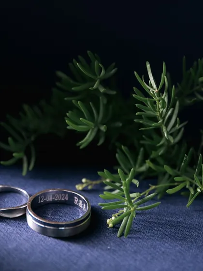 A creative shot of the wedding bands, with the wedding date engraved inside, symbolizing their new beginning.