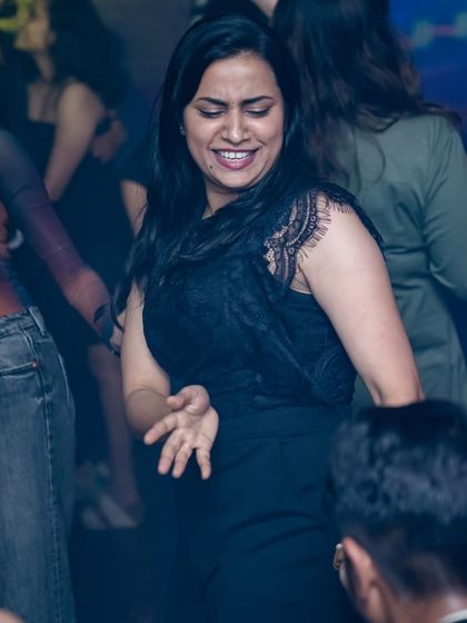 Feeling the rhythm and moving to the beat. A candid shot of someone lost in the music.