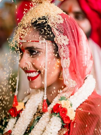 The bride's blissful smile during the 'talambralu' ritual. Our candid photography freezes these fleeting moments of pure happiness.