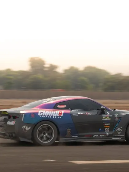 This side-on panning shot perfectly freezes the motion of a custom-liveried Nissan GTR, keeping the car sharp while the background streaks by.