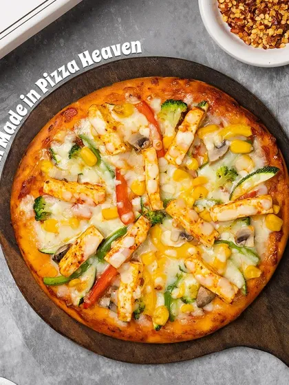A delicious close-up of our Paneer Pizza, topped with generous chunks of marinated paneer, colorful bell peppers, sweet corn, and gooey mozzarella cheese on a perfectly baked crust.