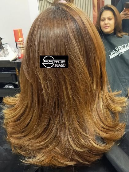 A classic layered haircut with a soft, feathered finish. This style is versatile and gives the hair a light, airy feel.