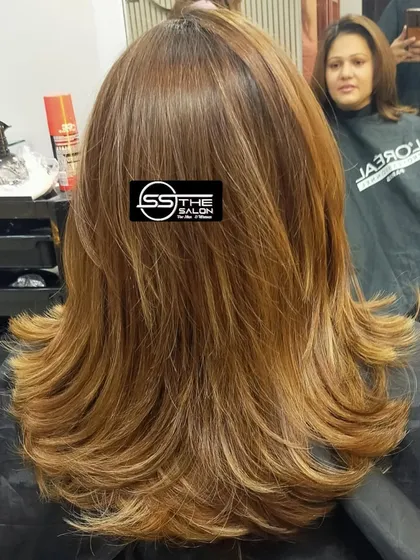 A classic layered haircut with a soft, feathered finish. This style is versatile and gives the hair a light, airy feel.