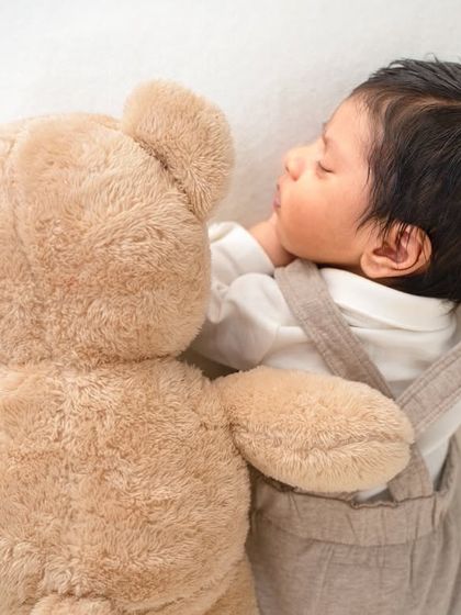 A sweet moment between a newborn and his teddy bear. Simple props like a favorite stuffed animal can add a personal and heartwarming touch.