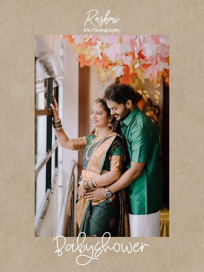 A candid moment from a baby shower, where the couple looks out a window together. The husband has his arm around his wife, sharing a quiet moment of reflection.