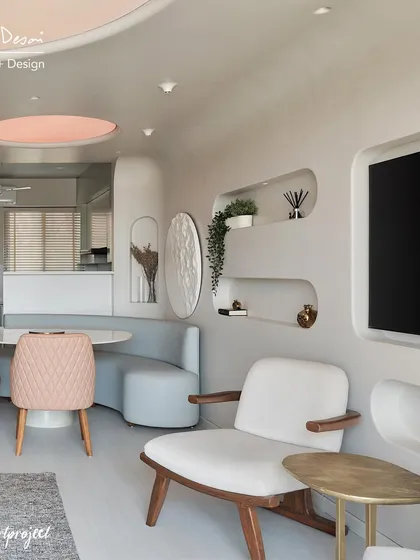 Another view of the Agra Fort living room, showing the built-in wall niches and curved banquette seating for the dining area. The design focuses on creating a seamless, flowing space with soft, rounded forms.