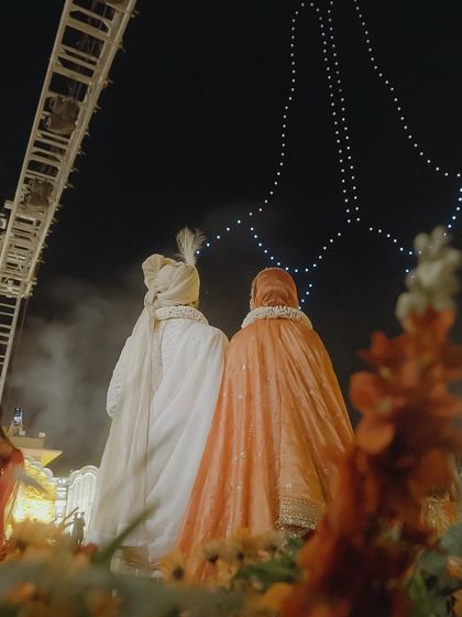 A couple stands together, watching their story unfold in the sky. This image captures the essence of our service: creating a shared, magical experience that becomes a core memory of the wedding day.